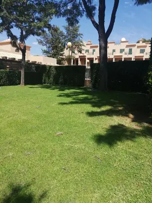 a yard with trees and a fence and a building at Villa V2 AA in Olhos de Água