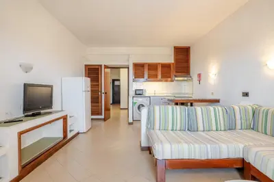 a living room with a couch and a tv at Bellavista Jardim By BeGuest in Albufeira
