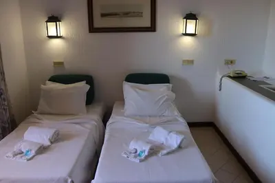 two beds in a room with towels on them at Bellavista Jardim By BeGuest in Albufeira