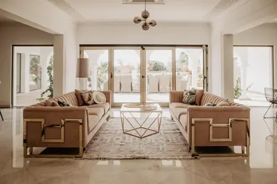 a living room with two couches and a rug at Granvila in Quarteira