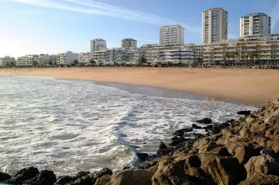 a view of a beach with buildings in the background at Apartamento Millenium Vista Mar- 2 passos da Praia in Quarteira