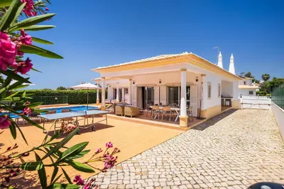 a villa with a patio and a swimming pool at Villa Ericeira by OCvillas in Albufeira