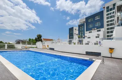 a swimming pool on the side of a building at Bay View by OCvillas in Albufeira