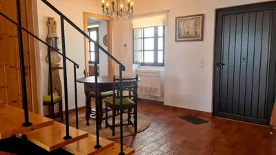 a hallway with a table and stairs in a house at Albufeira Beach Cliffs House in Albufeira