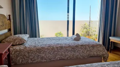 a bedroom with a bed with a stuffed animal on it at Albufeira Beach Cliffs House in Albufeira