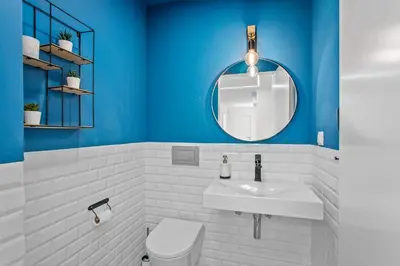 a blue bathroom with a sink and a mirror at Villa Ohana in Albufeira