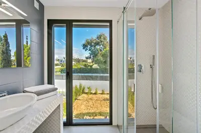a bathroom with a tub and a sink and a shower at Villa Ohana in Albufeira
