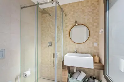 a bathroom with a sink and a glass shower at Villa Ohana in Albufeira
