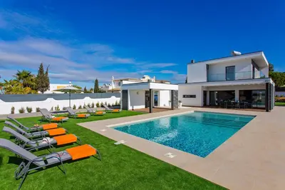 a villa with a swimming pool and a house at Villa Ohana in Albufeira
