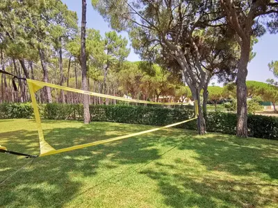 a yellow net in a yard with trees at Vila Planalto - Golfe - Entre o Golfe e o Mar in Vilamoura