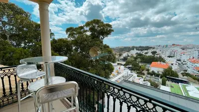 a balcony with two chairs and a table at Apartamentos Praia da Oura by Sunny Deluxe in Albufeira