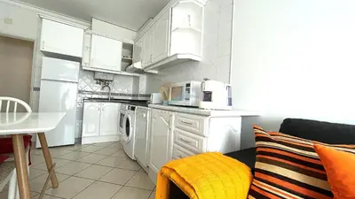 a kitchen with white cabinets and white appliances at Apartamentos Praia da Oura by Sunny Deluxe in Albufeira