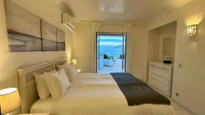 a bedroom with a bed with a view of the ocean at Beira Mar by Check-in Portugal in Albufeira