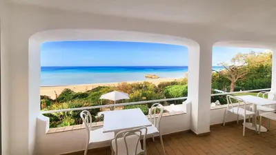 a room with a balcony with a view of the beach at Beira Mar by Check-in Portugal in Albufeira