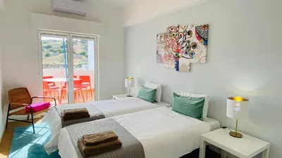 a bedroom with two beds and a table with a chair at Rooftop by Check-in Portugal in Albufeira