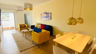 a living room with a couch and a table and chairs at Rooftop by Check-in Portugal in Albufeira