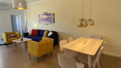 a living room with a couch and a table and chairs at Rooftop by Check-in Portugal in Albufeira