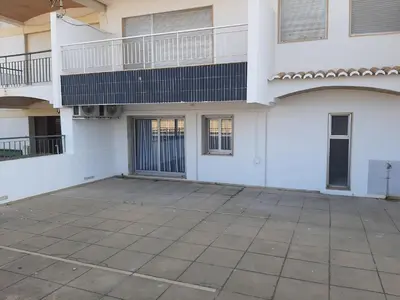 an empty parking lot in front of a building at Quarteira SeaSide in Quarteira