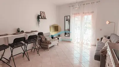 a white living room with a table and chairs at Kamaleon Sol by Sunny Deluxe in Albufeira