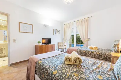 a hotel room with two beds and a tv at Villa Dome by OCvillas in Albufeira