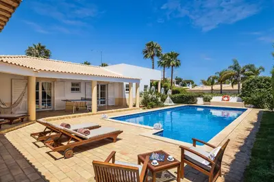 a backyard with a swimming pool and a house at Villa Dome by OCvillas in Albufeira