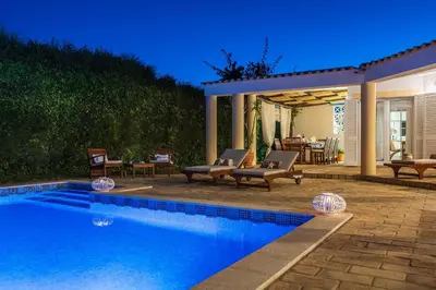 a backyard with a swimming pool and a patio at Villa Dome by OCvillas in Albufeira
