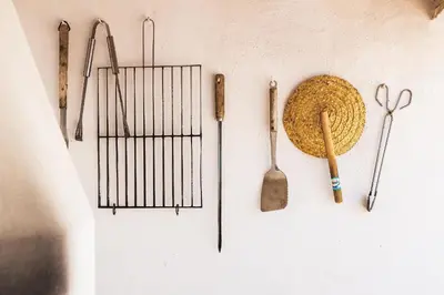 a wall with various tools hanging on a wall at Casa da Bia by OCvillas in Albufeira