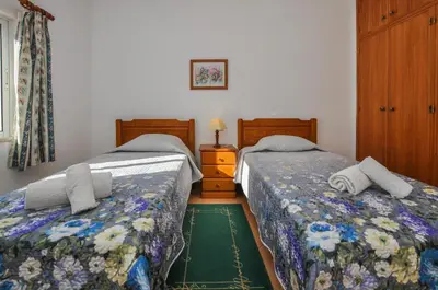 two beds sitting next to each other in a bedroom at Casa da Bia by OCvillas in Albufeira