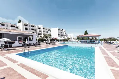 a large swimming pool in front of some buildings at Seaview Studio - 10 Min. Beach, Private Condo, Pool, Grill & Free Parking in Albufeira