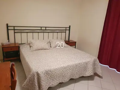 a bedroom with a bed with two wedding signs on it at Hospedaria do Almargem in Quarteira