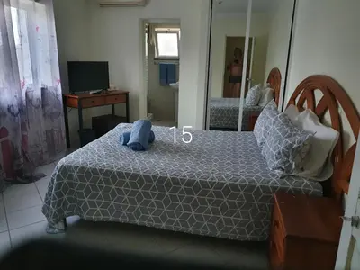 a bedroom with a bed with a blue stuffed animal on it at Hospedaria do Almargem in Quarteira