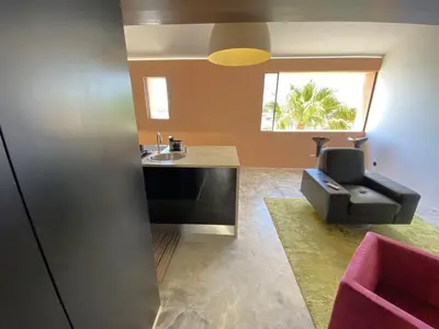 a bathroom with a sink and a couch in a room at Vilamoura Marina Mezzanine Loft in Vilamoura