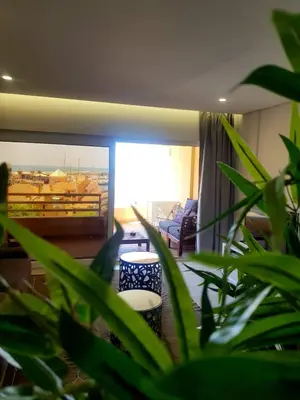 a living room with a couch and some green plants at Marina Mar Vilamoura Apartment in Vilamoura