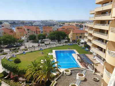 an apartment with a swimming pool in a city at Marina Mar Vilamoura Apartment in Vilamoura