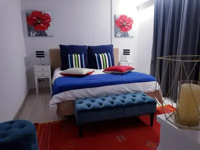 a bedroom with a blue bed and a blue bench at Marina Mar Vilamoura Apartment in Vilamoura