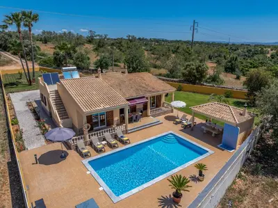 an aerial view of a house with a swimming pool at Villa Monte Velho in Albufeira