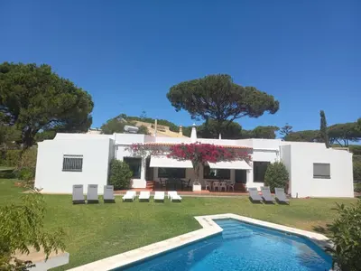 a house with a swimming pool in front of it at Villa Azevedo in Vilamoura
