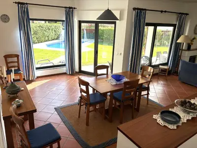 a white table and chairs on a patio at Villa Azevedo in Vilamoura