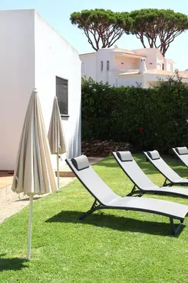 a bathroom with a toilet and a glass shower at Villa Azevedo in Vilamoura