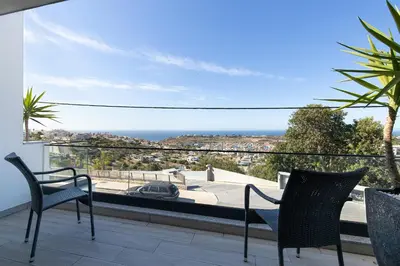 a patio with a table and chairs and a swimming pool at Villa Tropicana in Albufeira