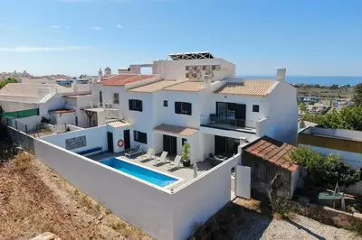 a view of a town with the ocean in the background at Villa Tropicana in Albufeira