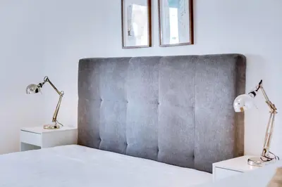 a bedroom with a bed with two lamps at AL - Apartamento Egas Moniz in Quarteira