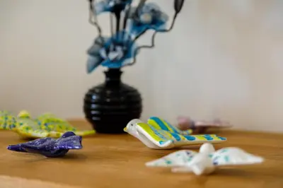 a table with a vase with a group of toothbrushes at AlbufeiraMar Apartment in Albufeira