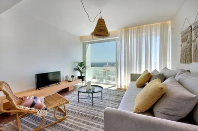 a living room with a couch and a tv at Apartamento Boavista - Sea View by DreamvillasAlbufeira in Albufeira