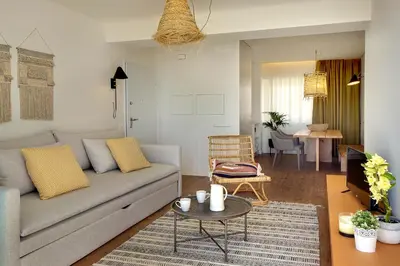 a living room with a couch and a table at Apartamento Boavista - Sea View by DreamvillasAlbufeira in Albufeira