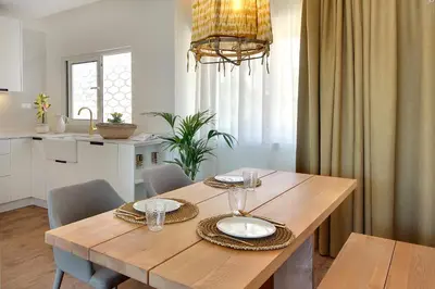 a wooden table with two plates on it in a kitchen at Apartamento Boavista - Sea View by DreamvillasAlbufeira in Albufeira