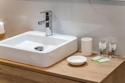 a bathroom with a sink and a bowl on a counter at AL - Apartamento Vidal Mar in Quarteira