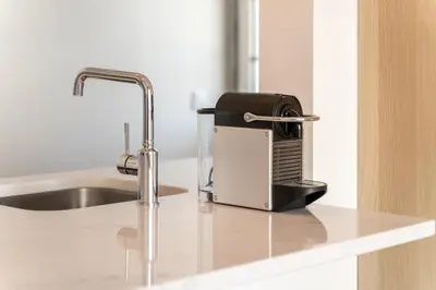 a toaster sitting on a counter next to a sink at AL - Apartamento Vidal Mar in Quarteira