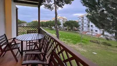 a balcony with a table and chairs and a view of a building at T2 Apartment Falesia Beach Albufeira in Roja- Pé