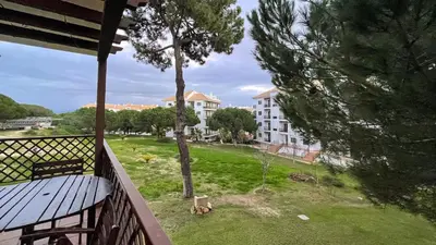 a balcony with a view of a park and a building at T2 Apartment Falesia Beach Albufeira in Roja- Pé